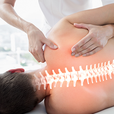 Chiropractor adjusting patient with illuminated spine